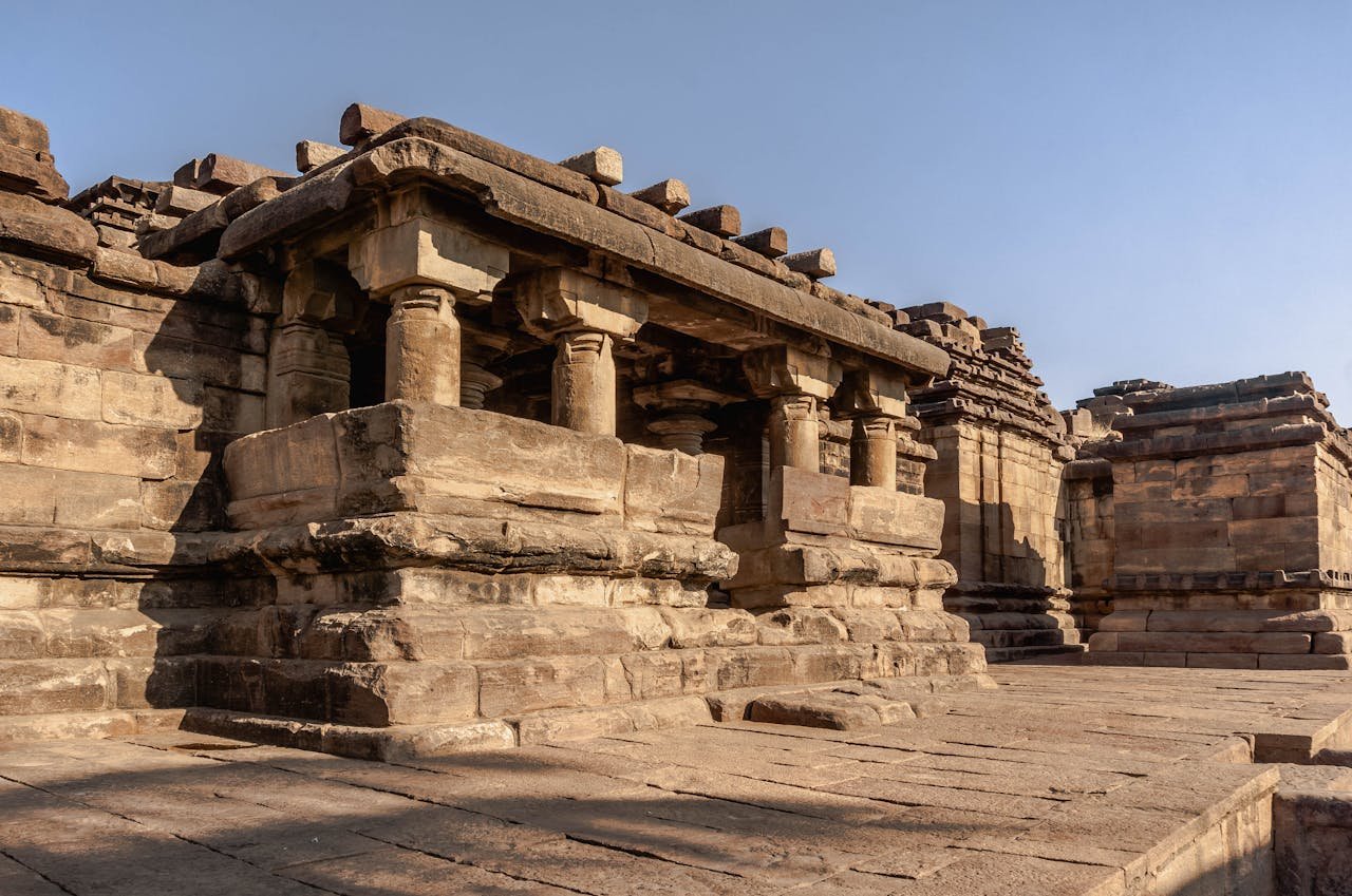 hero-img-02 Explore the historic stone temple architecture of Aihole, Karnataka, India.