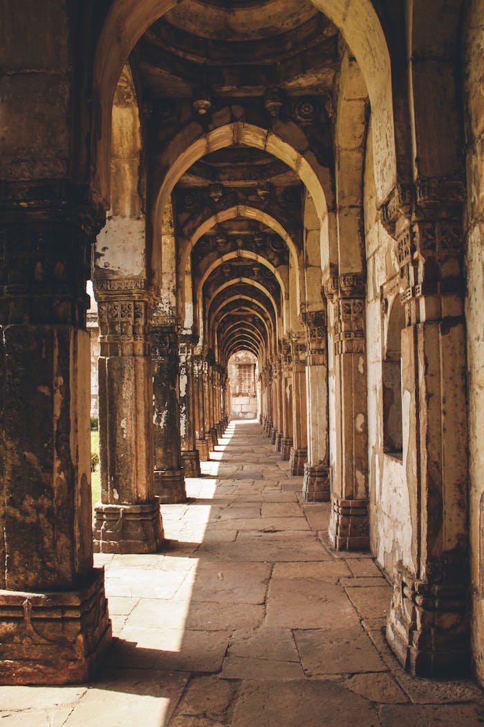 Explore the ancient arches of the Jama Mosque, a UNESCO World Heritage Site in Champaner, India.