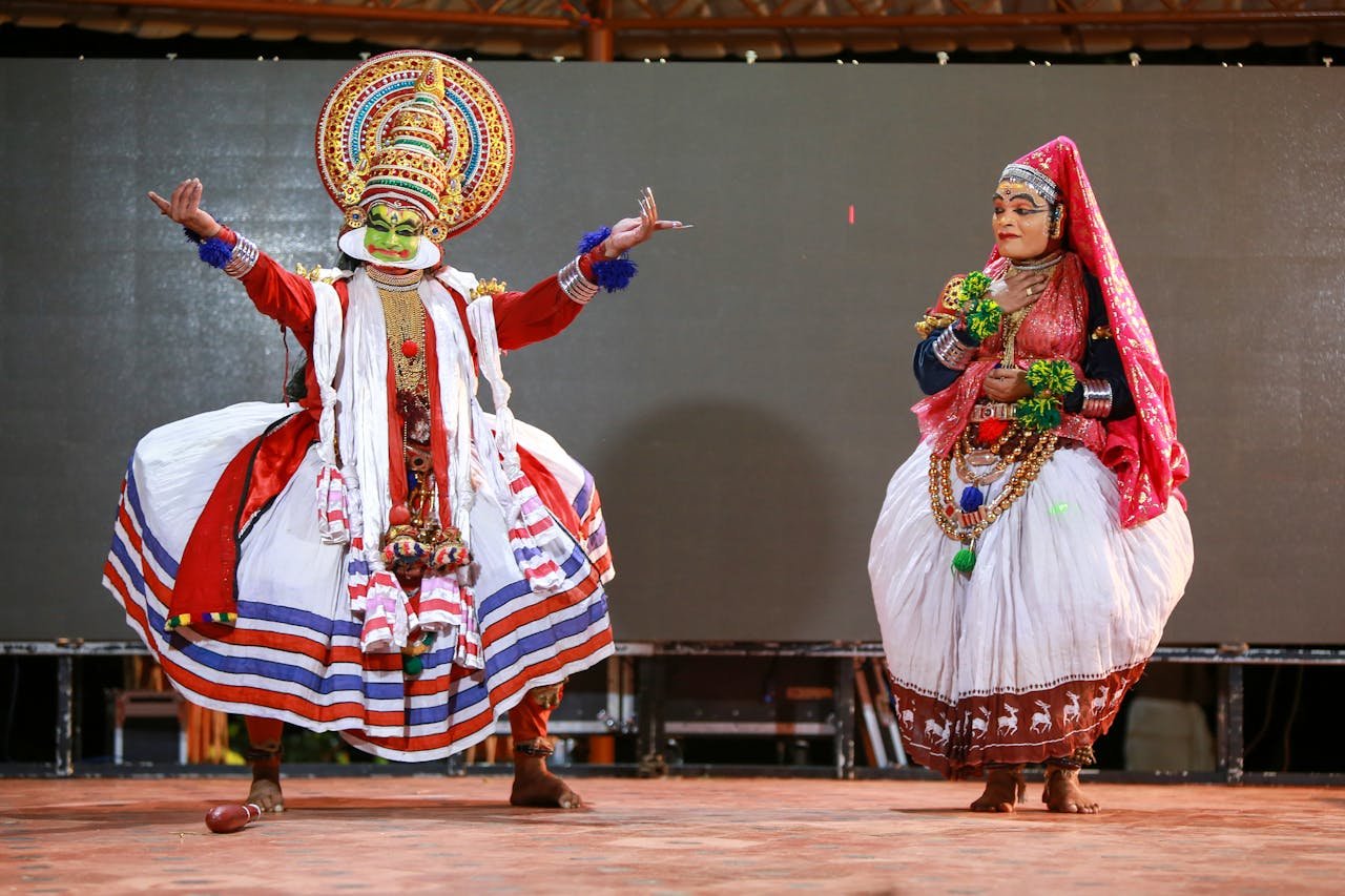 services-02 Vibrant Kathakali dancers performing in traditional costumes at a cultural event in Kerala, India.